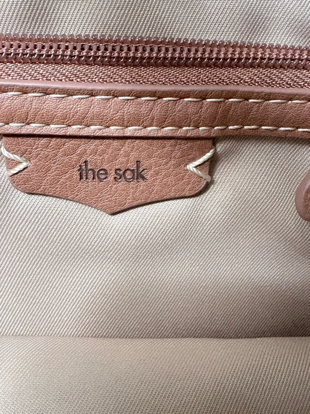 The Sak Black Leather Shoulder Bag with Tan Tassel Charm